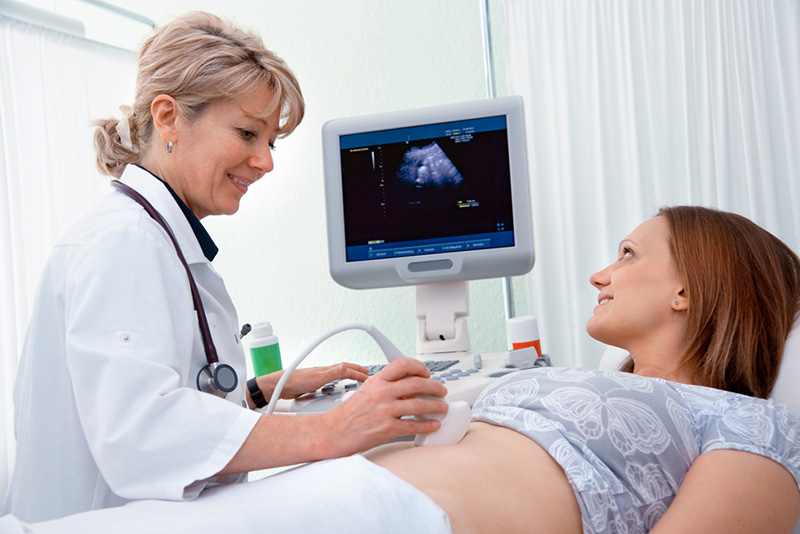 Pregnant woman getting ultrasound